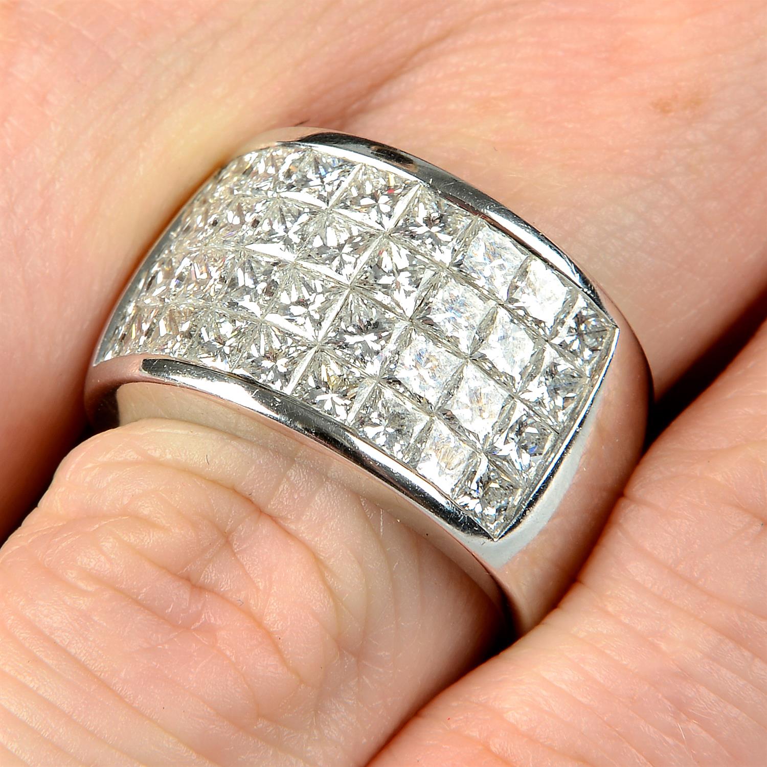 A pavé-set diamond band ring.