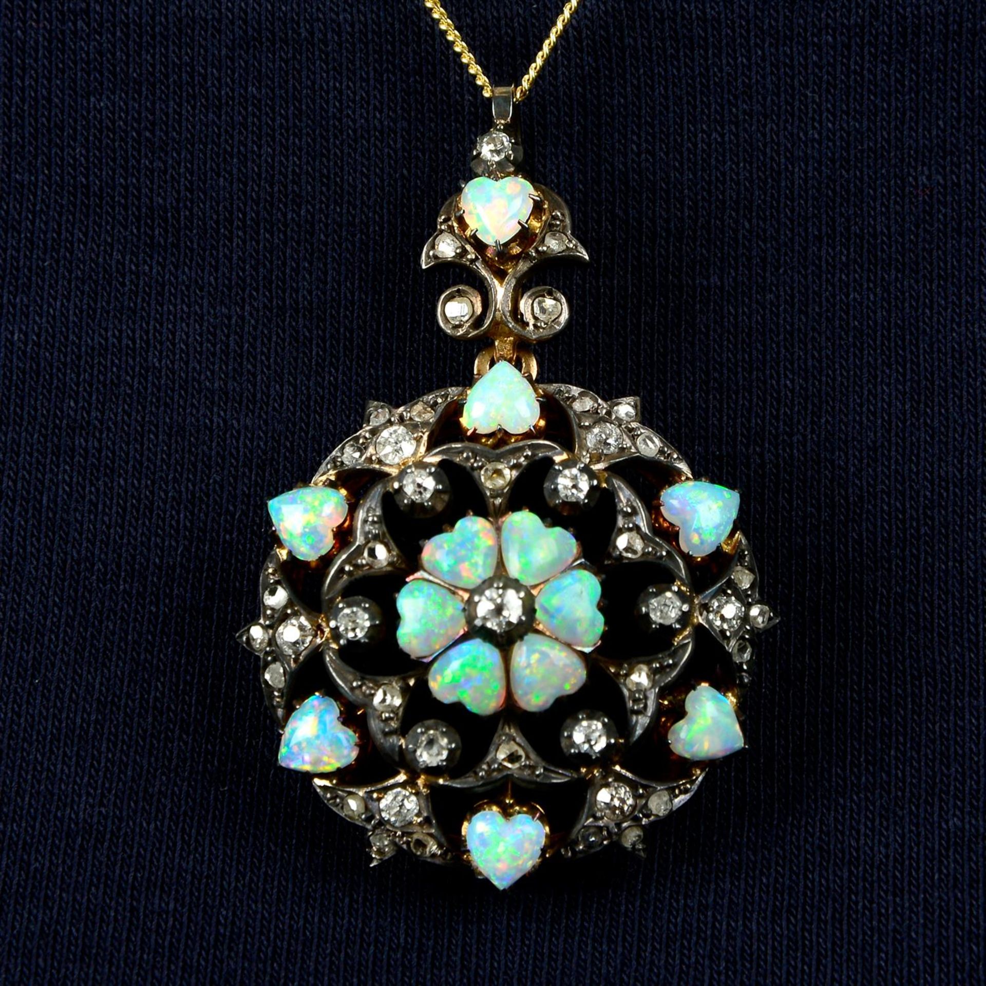 A silver and gold, late 19th century opal heart and diamond pendant/brooch.