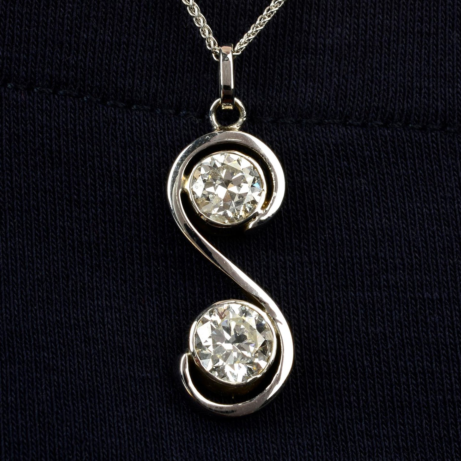 A brilliant-cut diamond two-stone pendant, with 18ct gold chain.