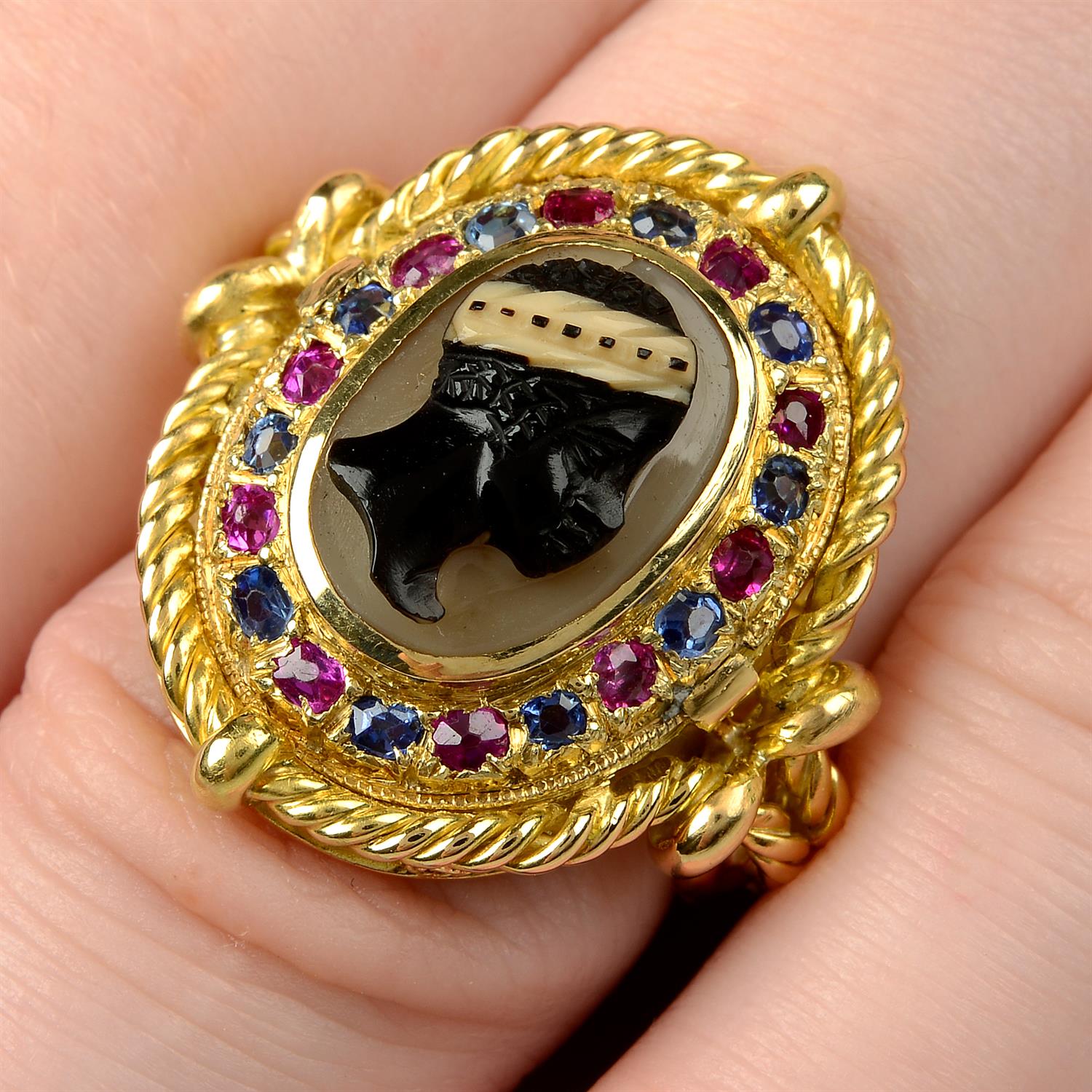 An onyx cameo, sapphire and ruby ring.