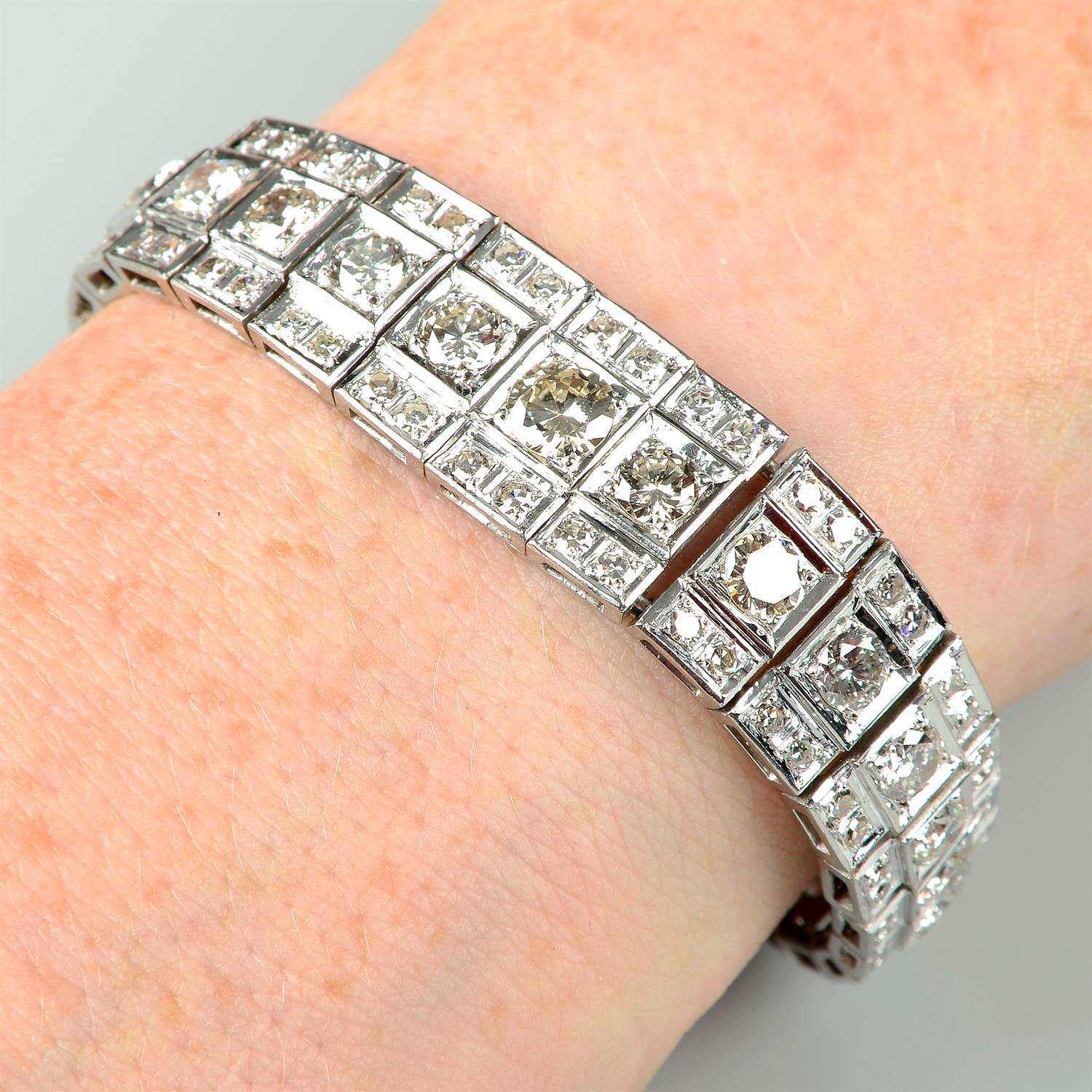 A graduated brilliant-cut diamond line bracelet, with single-cut diamond line sides.