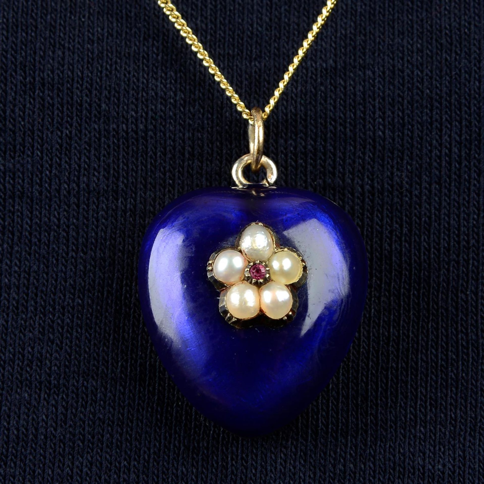 A late Victorian ruby and split pearl floral motif, blue enamel heart locket.