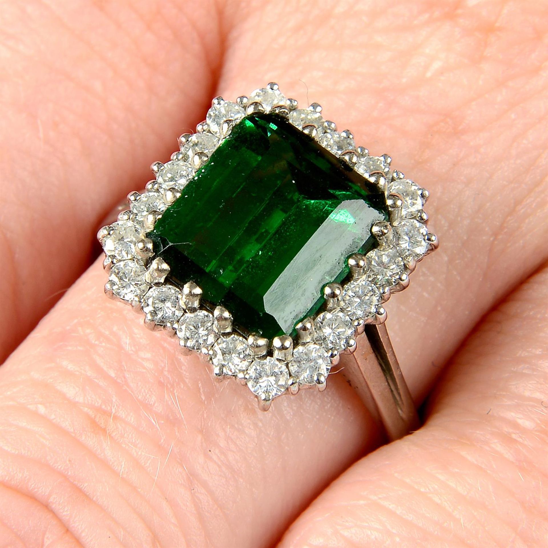 A green tourmaline and brilliant-cut diamond cluster ring.