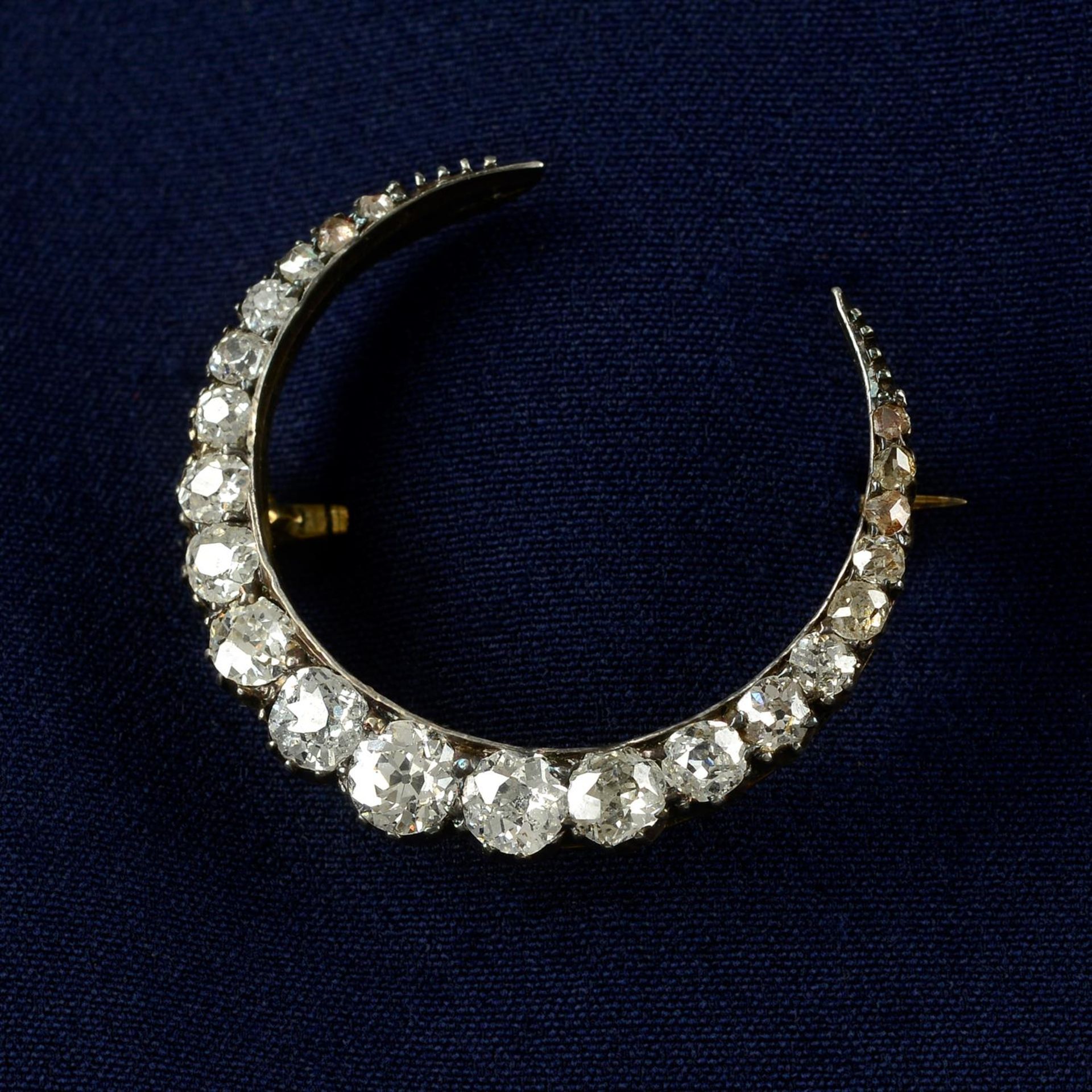 A late Victorian silver and gold, old and rose-cut diamond crescent brooch.