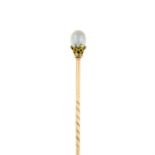 A mid 19th century gold pearl stick pin, with white enamel detail.