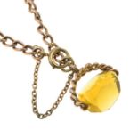 An early 20th century 9ct gold curb-link bracelet, suspending a yellow paste fob.