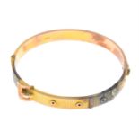 A 9ct gold buckle bangle.