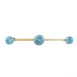 A 9ct gold blue zircon three-stone brooch.