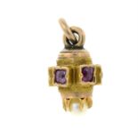 A late 19th century gold ruby charm / pendant.