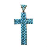 A turquoise cross pendant.