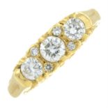 An 18ct gold brilliant-cut diamond three-stone ring, with similarly-cut diamond double spacers.