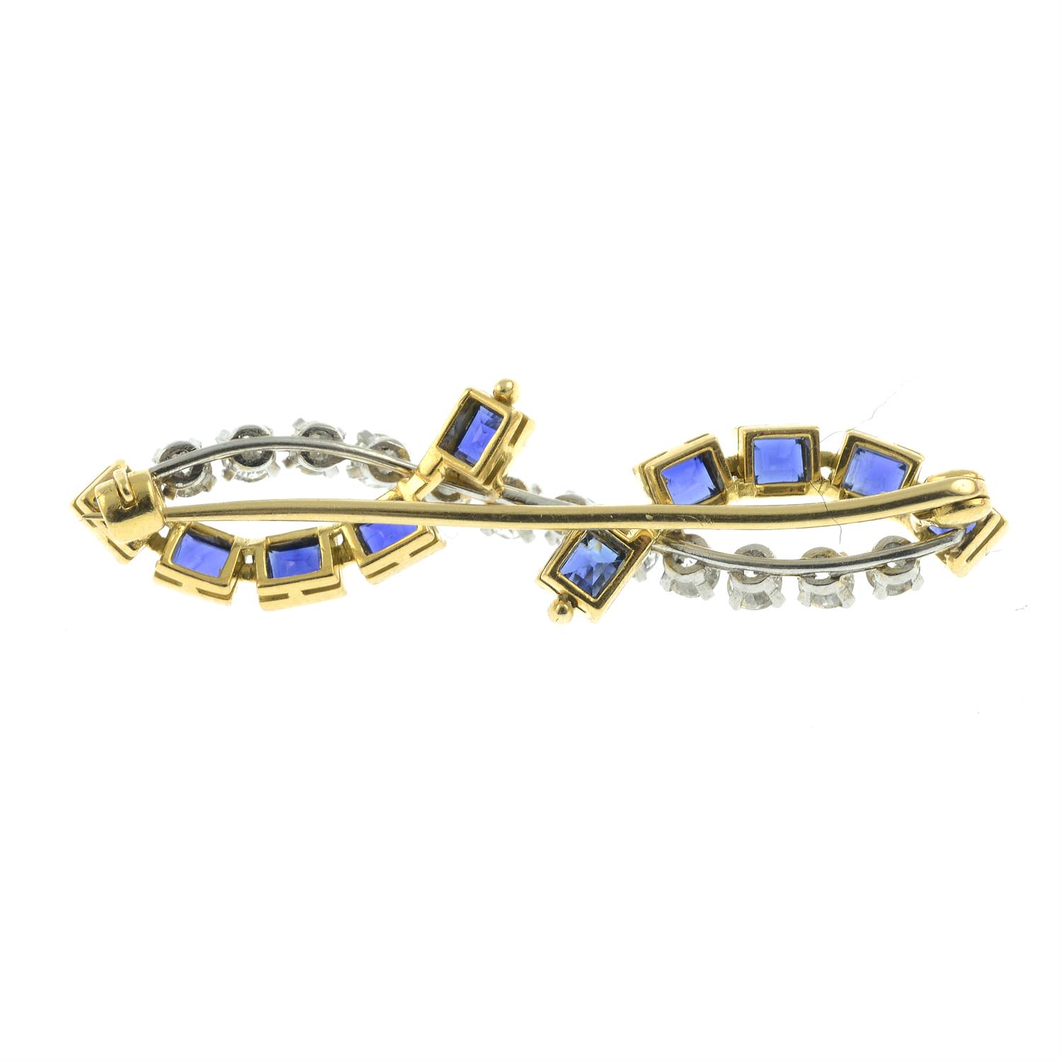 An early 20th century brilliant-cut diamond and sapphire brooch, depicting an undulating line. - Image 2 of 2