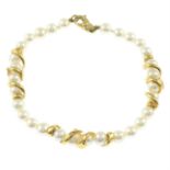 A cultured pearl bracelet, with scrolling foliate spacers and lobster clasp.