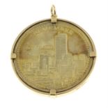 A '9-11 American Heroes' remembrance coin, within a 9ct gold pendant mount.