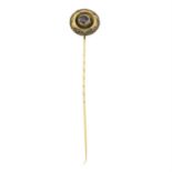 A late 19th century gold garnet stickpin.