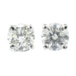 A pair of brilliant-cut diamond stud earrings.