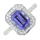 An 18ct gold tanzanite and diamond cluster ring, with diamond line shoulders.