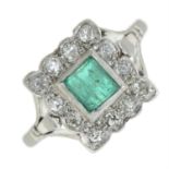 An emerald and diamond cluster ring.