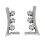 A pair of brilliant-cut diamond earrings.