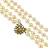 A cultured pearl two-row necklace, with floral clasp.