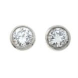 A pair of brilliant-cut diamond stud earrings.