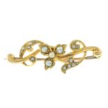 An early 20th century 15ct gold split and seed pearl scrolling foliate bar brooch.