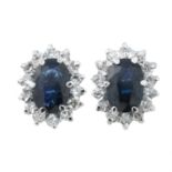 A pair of sapphire and diamond cluster earrings.