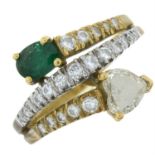 An 18ct gold emerald and diamond crossover ring.