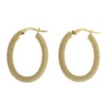 Two pairs of hoop earrings.