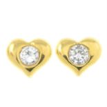 A pair of brilliant-cut diamond heart-shape stud earrings.