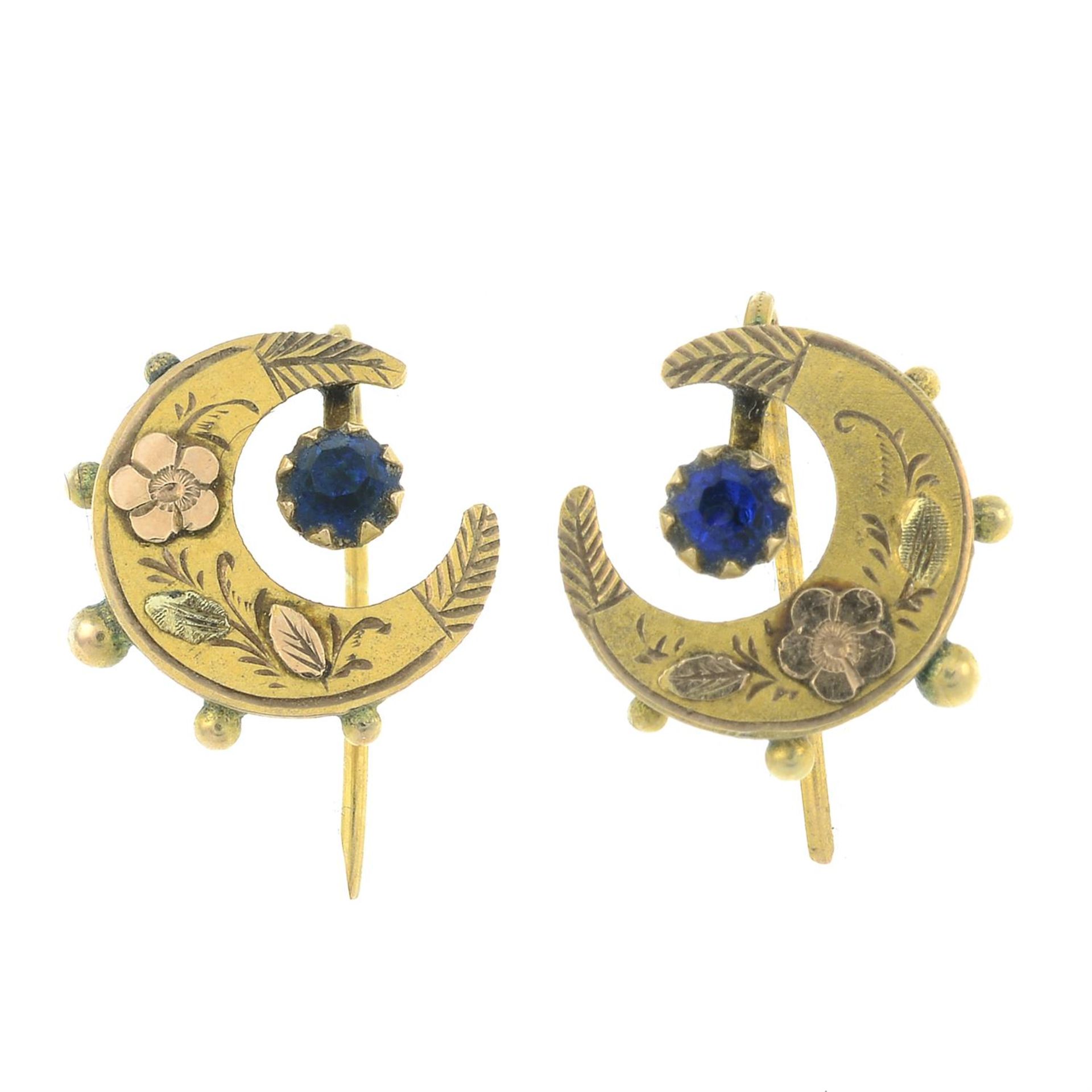 A pair of early 20th century 9ct gold bi-colour crescent earrings, each with blue paste accent.