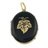 An early 20th century black enamel locket, with split pearl accent.