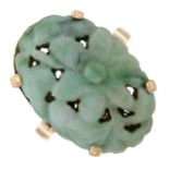 A carved jade dress ring, depicting a floral panel.