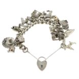 A curb-link charm bracelet, suspending twenty charms, gathered at a silver heart-shape padlock