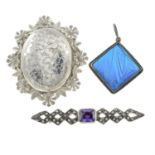 A selection of jewellery, comprising a charm bracelet, three brooches, a pendant,