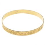 A 9ct gold bangle.