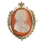 An early 20th century gold carnelian cameo and split pearl brooch, carved to depict a gentleman in