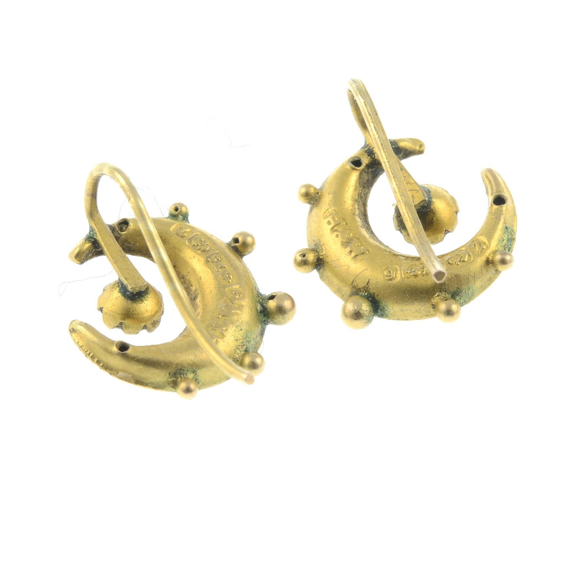 A pair of early 20th century 9ct gold bi-colour crescent earrings, each with blue paste accent. - Bild 2 aus 2