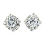 A pair of brilliant-cut diamond stud earrings.