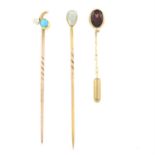 Three gem-set stickpins.