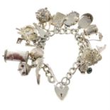 A curb-link charm bracelet, suspending sixteen charms, gathered at a silver heart-shape padlock