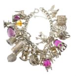 A charm bracelet, suspending twenty-three charms.