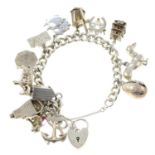 A curb-link charm bracelet, suspending thirteen charms, gathered at a silver heart-shape padlock