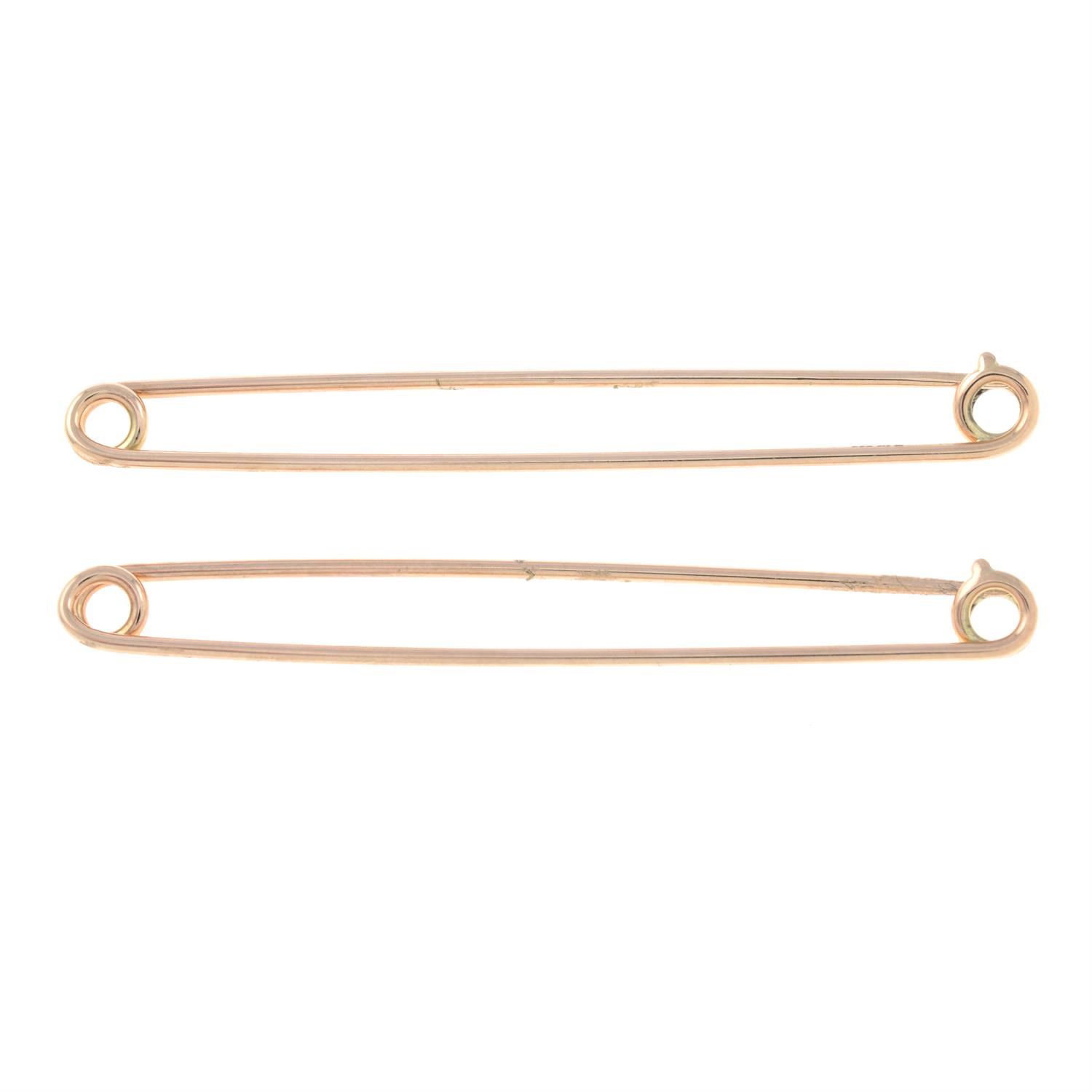 Two 9ct gold safety pins.