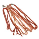 Five coral bead necklaces.