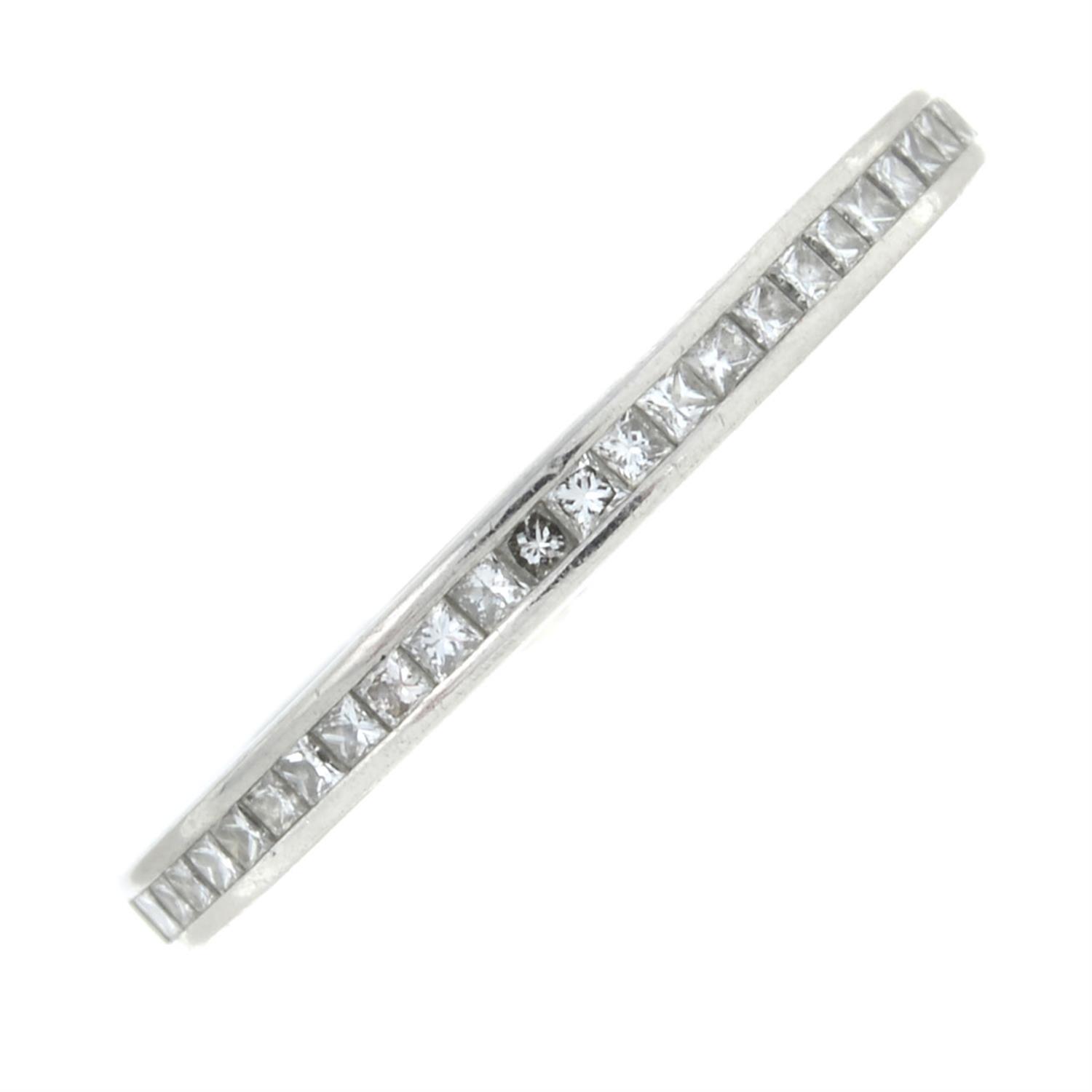 A platinum square-shape diamond half eternity ring.