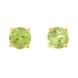 A pair of peridot stud earrings.