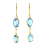 A pair of blue topaz drop earrings.