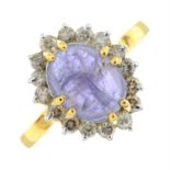 A cabochon tanzanite and brilliant-cut diamond cluster ring.