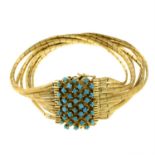 A multi-strand bracelet, with turquoise clasp.